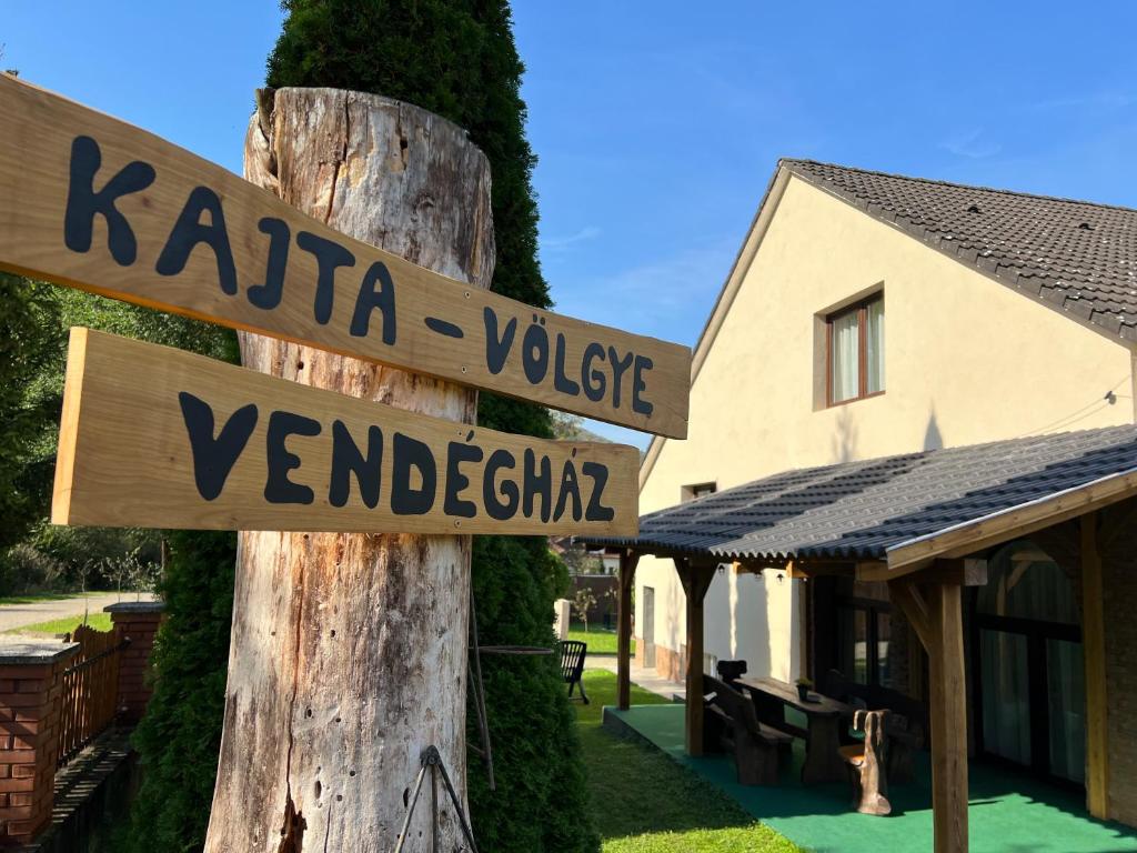 una señal que lee Karaia Village y real en Kajta-Völgye Guesthouse, Jósvafő, National Park Aggtelek, en Jósvafő