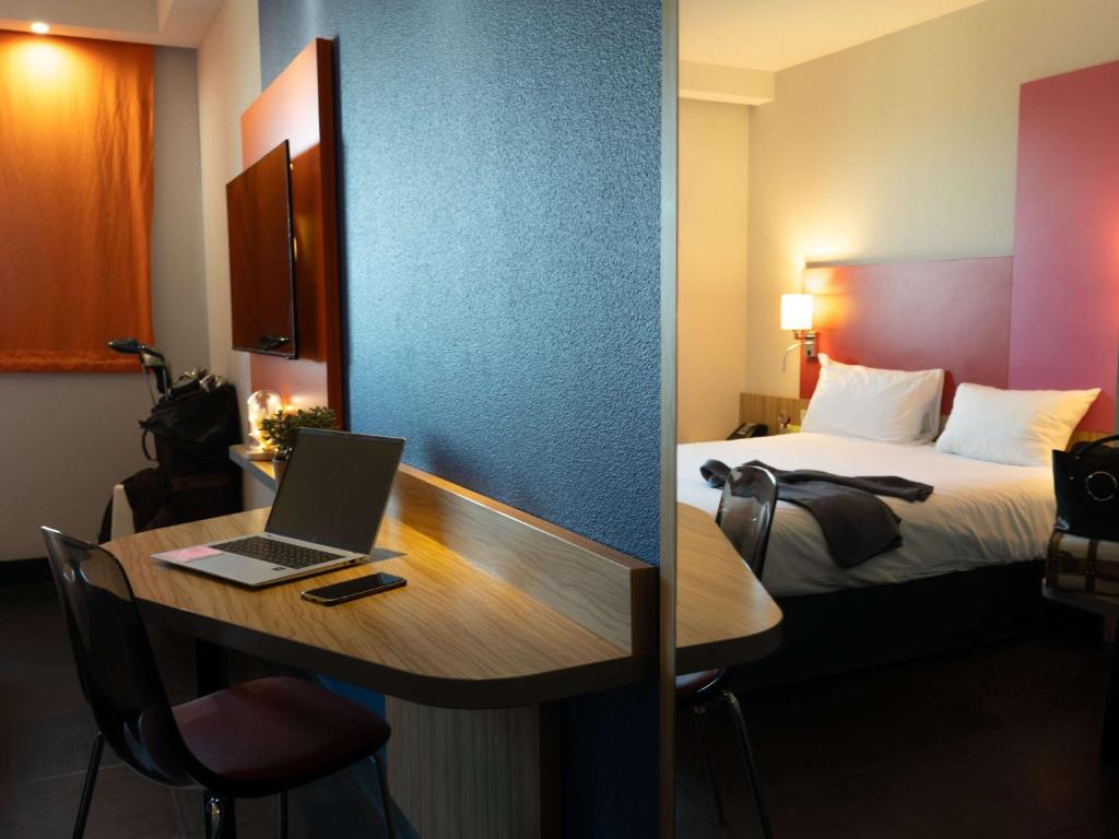 Postel nebo postele na pokoji v ubytování ibis Styles Romans-Valence Gare TGV