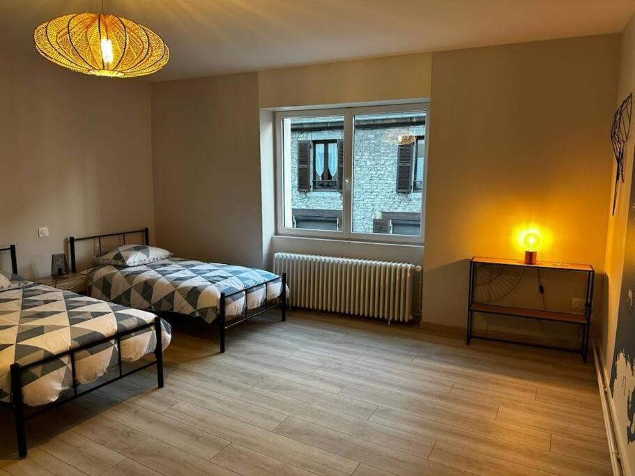 מיטה או מיטות בחדר ב-Les Lunetiers