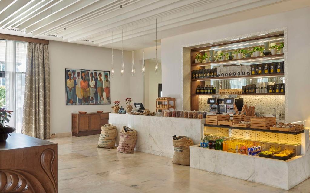 a restaurant with a counter and a bar at Hyatt Regency Addis Ababa in Addis Ababa