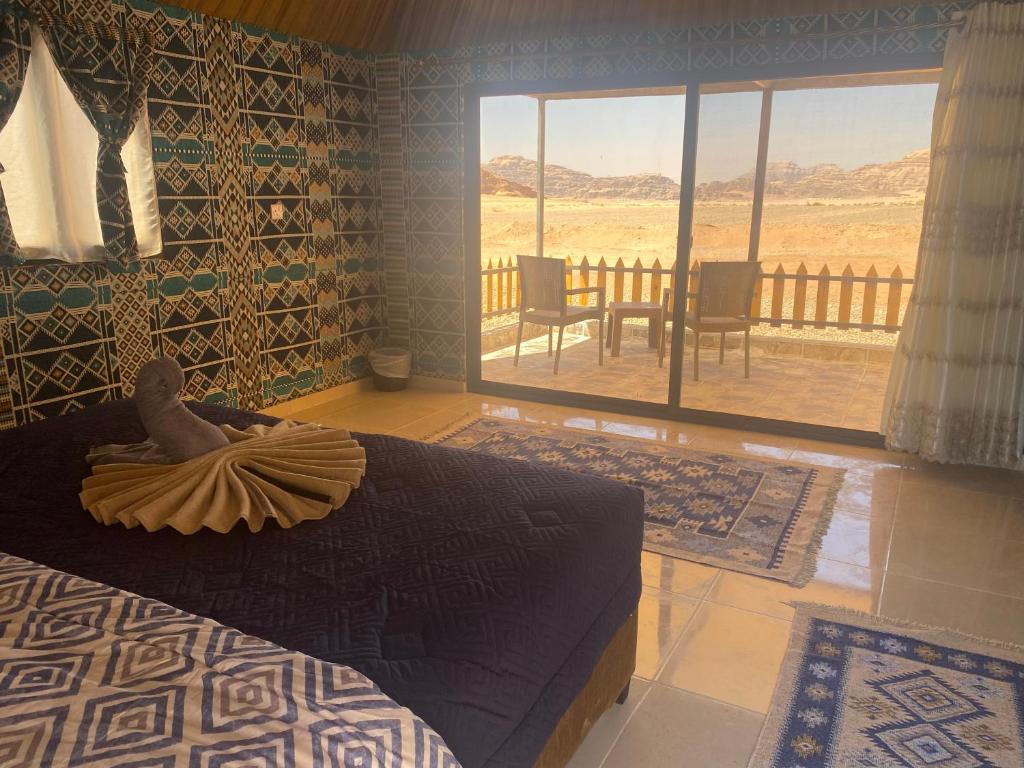 瓦迪拉姆的住宿－Sunrise Colors Camp Wadi rum，一间卧室,配有一张床,上面有秃鹰