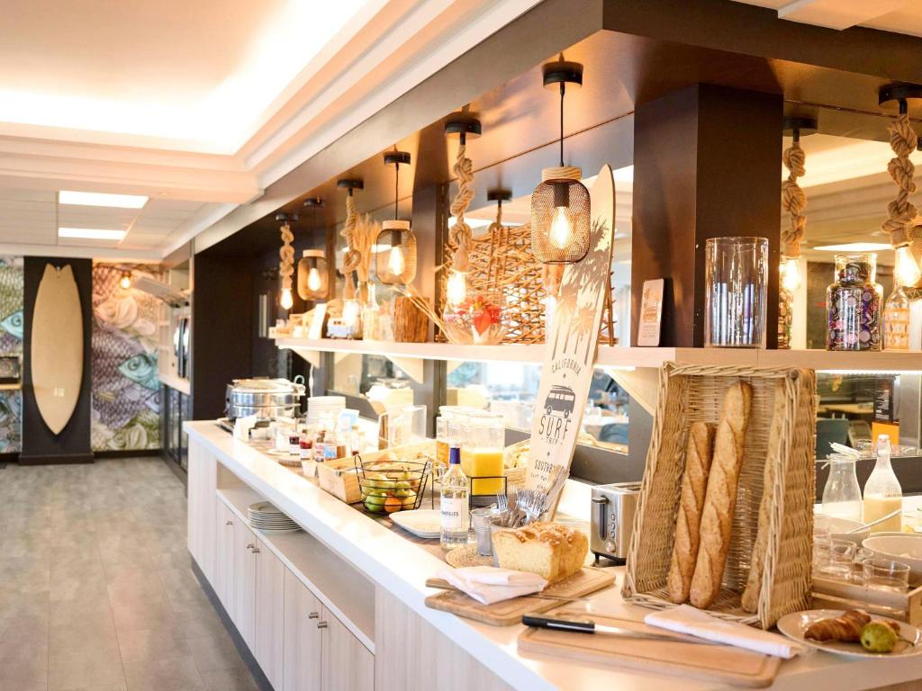 a bakery with a counter with food on it at ibis Styles Bordeaux Begles in Bègles