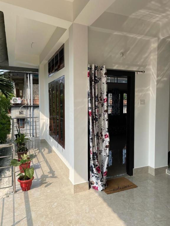 a building with a door with a curtain on it at Hrishi’s home in Guwahati