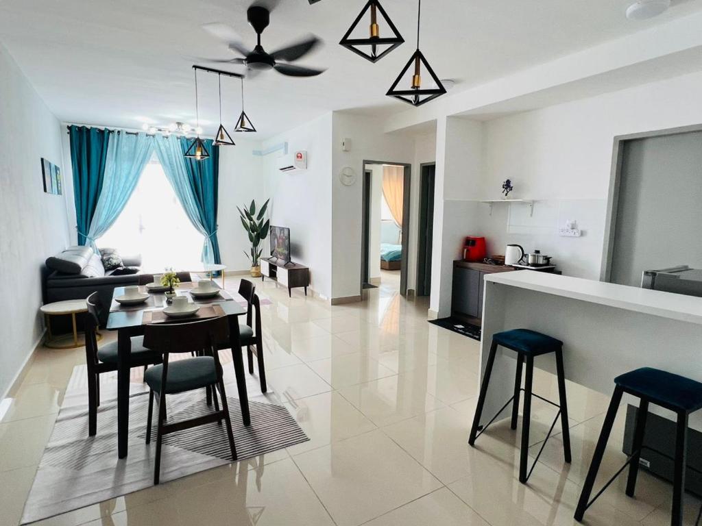 a kitchen and living room with a table and chairs at JC HOMESTAY RAWANG in Rawang