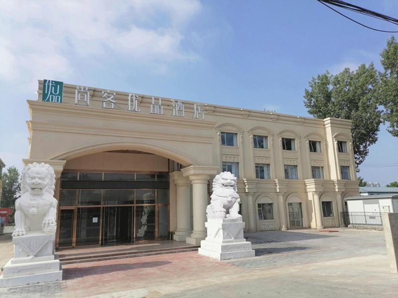 a large building with two statues in front of it at Thank Inn Plus Beijing Yizhuang Maju Bridge Jinghai Road in Tongzhou