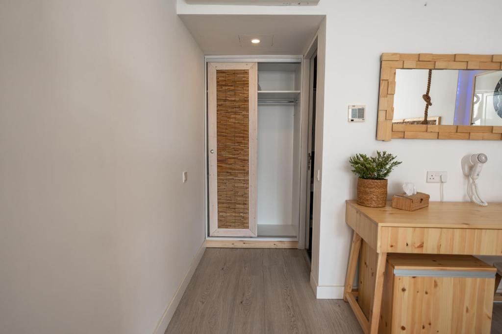 a room with a hallway with a door and a table at Blue Harbour Boutique in Ayia Napa