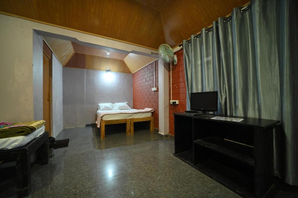 Postel nebo postele na pokoji v ubytování Coorg HomeStay Resort