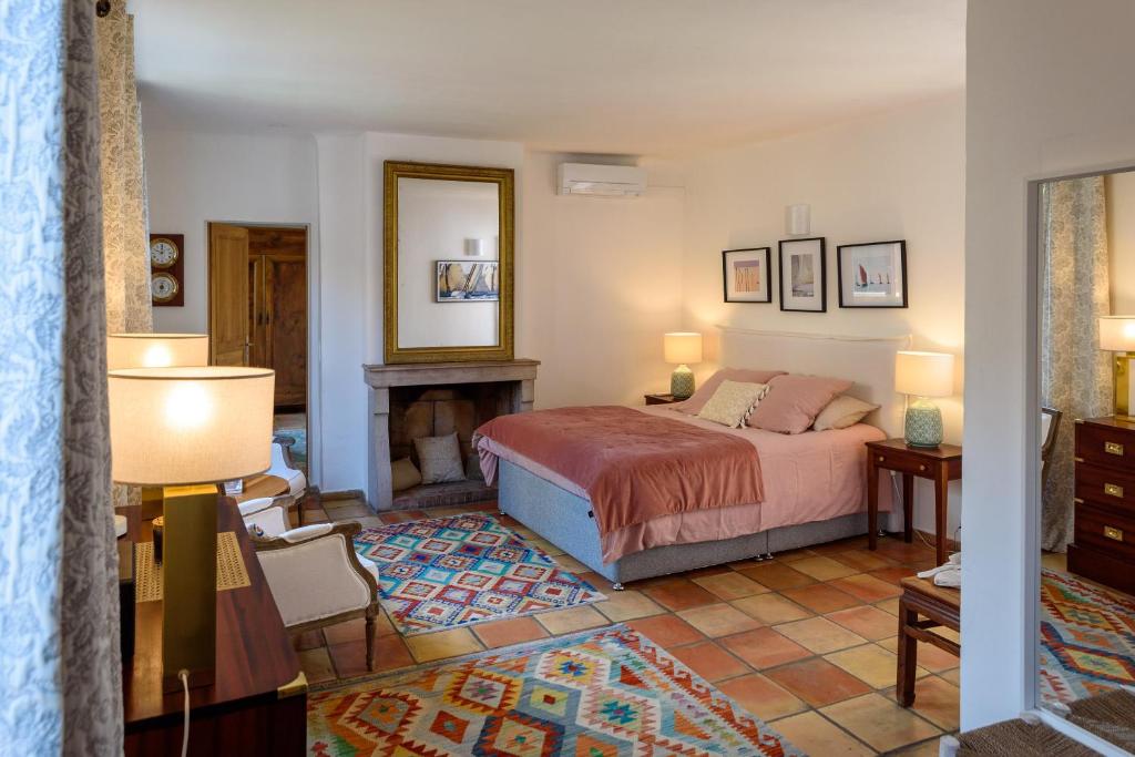 - une chambre avec un lit et une cheminée dans l'établissement Maison Magdeleine, à Saint-Tropez