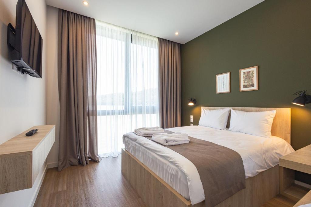 Postel nebo postele na pokoji v ubytování Apart Hotel Kundzuli