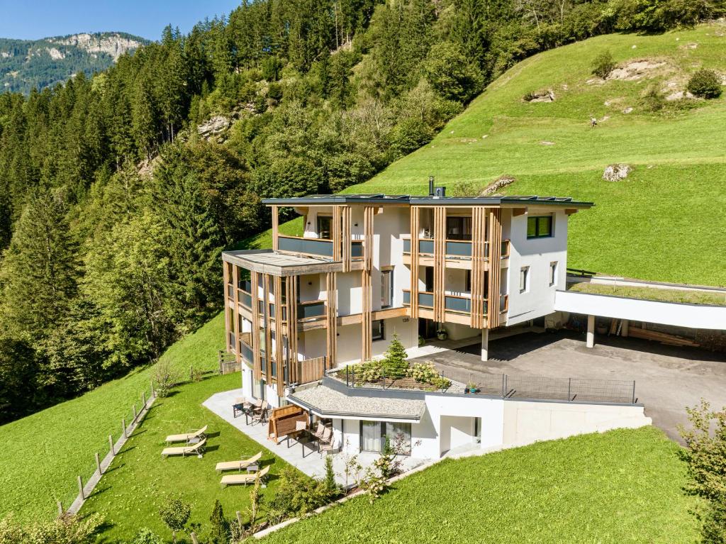 an aerial view of a house on a hill at Natur Zeit - Alpine Garden Apartments in Mayrhofen