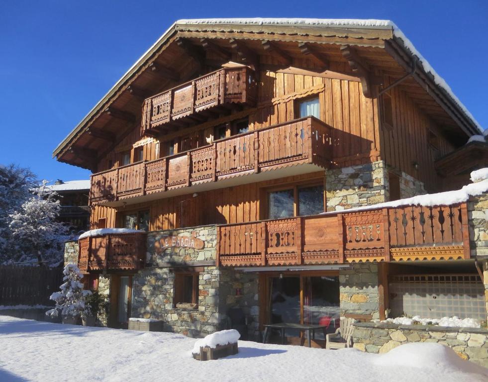 a large wooden building with wooden balconies on it at Les Dolomites in La Plagne Tarentaise