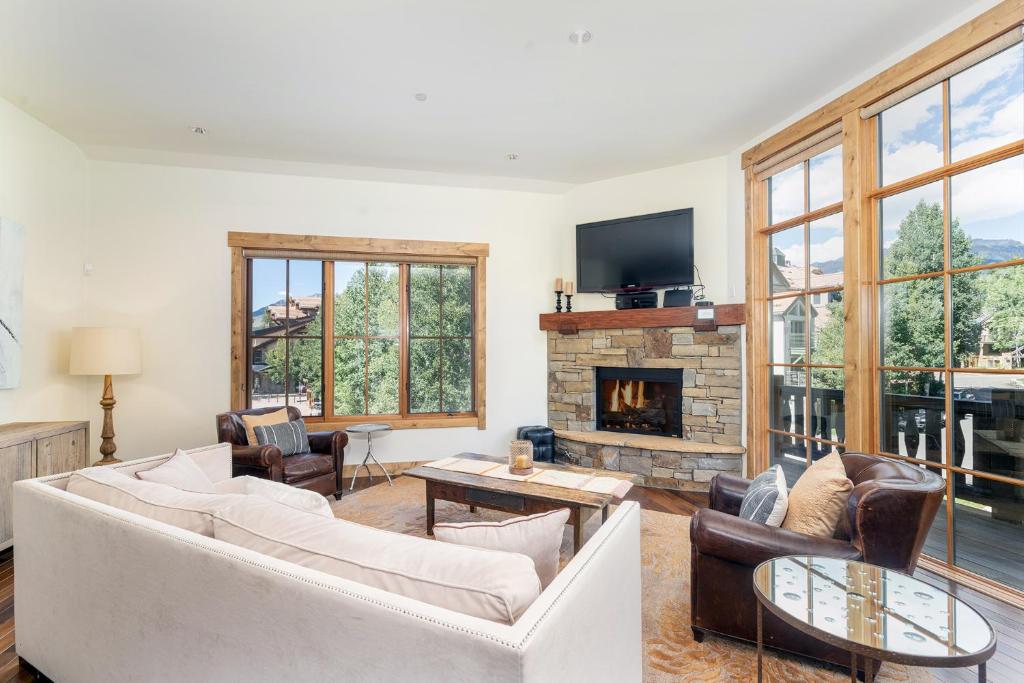 a living room with a couch and a fireplace at Belvedere 4 townhouse in Telluride