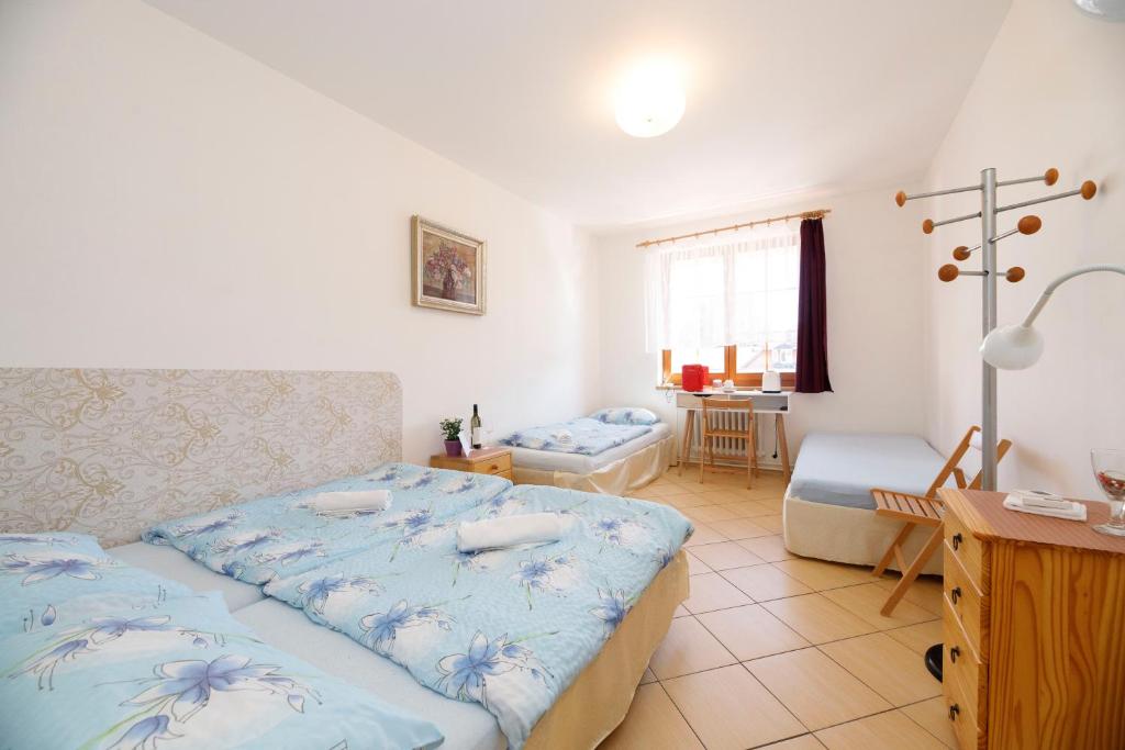 Postel nebo postele na pokoji v ubytování Hotel Vintíř