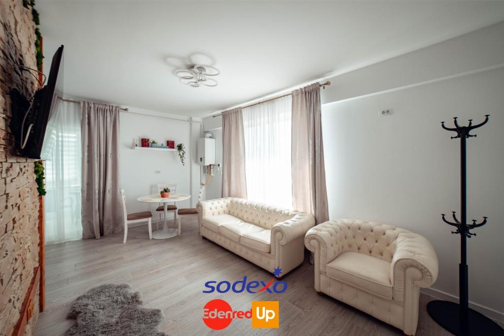 a living room with two couches and a table at Palace of Culture Dream Apartments and Studios Iasi in Iaşi