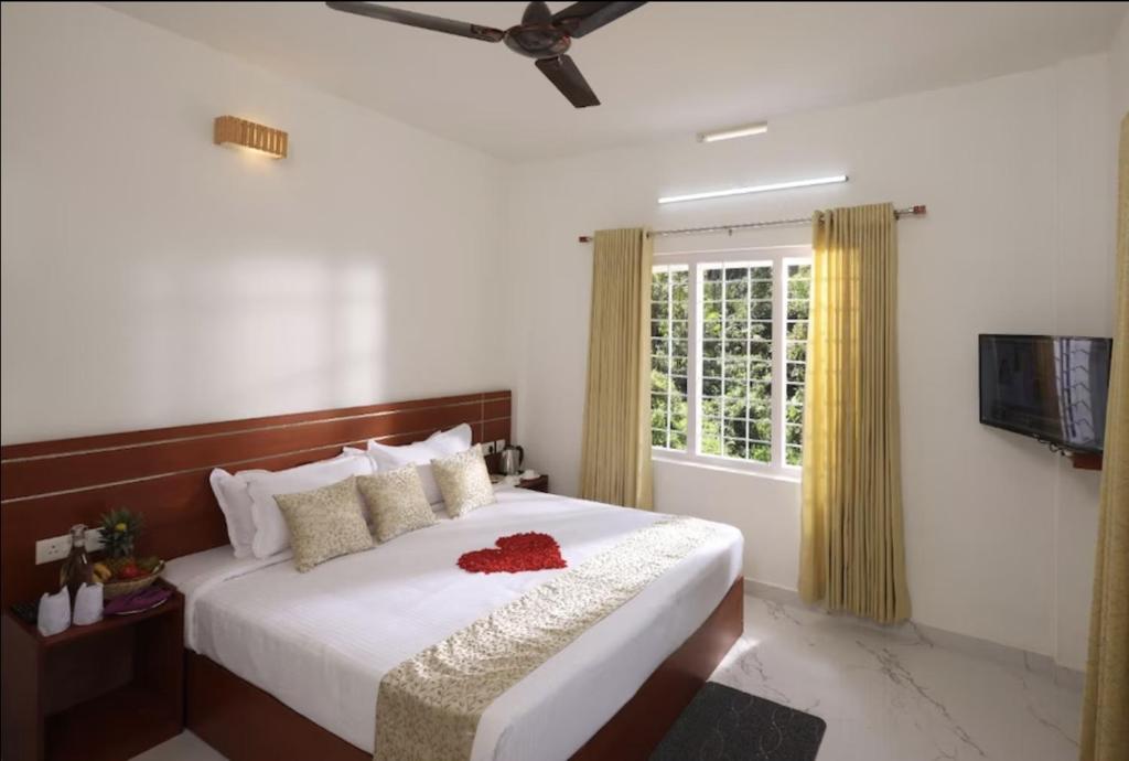 a bedroom with a large white bed with a window at Shiv Dwelling - Full Villa in Ujjain
