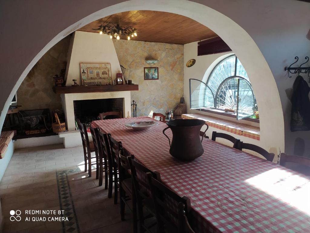 a dining room with a table and chairs and a fireplace at casale fucino monolocale in Avezzano