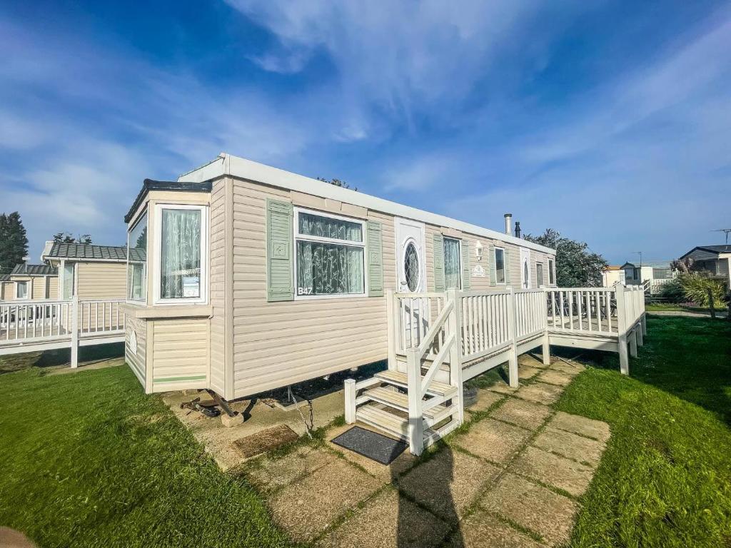 a white holiday home with a large deck at Spacious Caravan For Hire In Hunstanton At Manor Park Holiday Park Ref 23047b in Hunstanton
