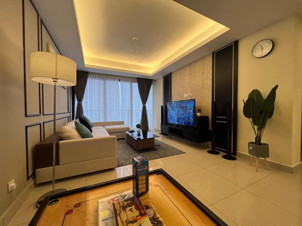 a living room with a couch and a tv at QUINCE HOME GRAND ION DELEMEN GENTING HIGHLANDs in Genting Highlands