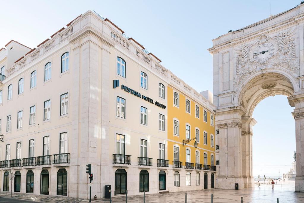 a building with an arch and a building with a clock at Pestana Rua Augusta Lisboa in Lisbon