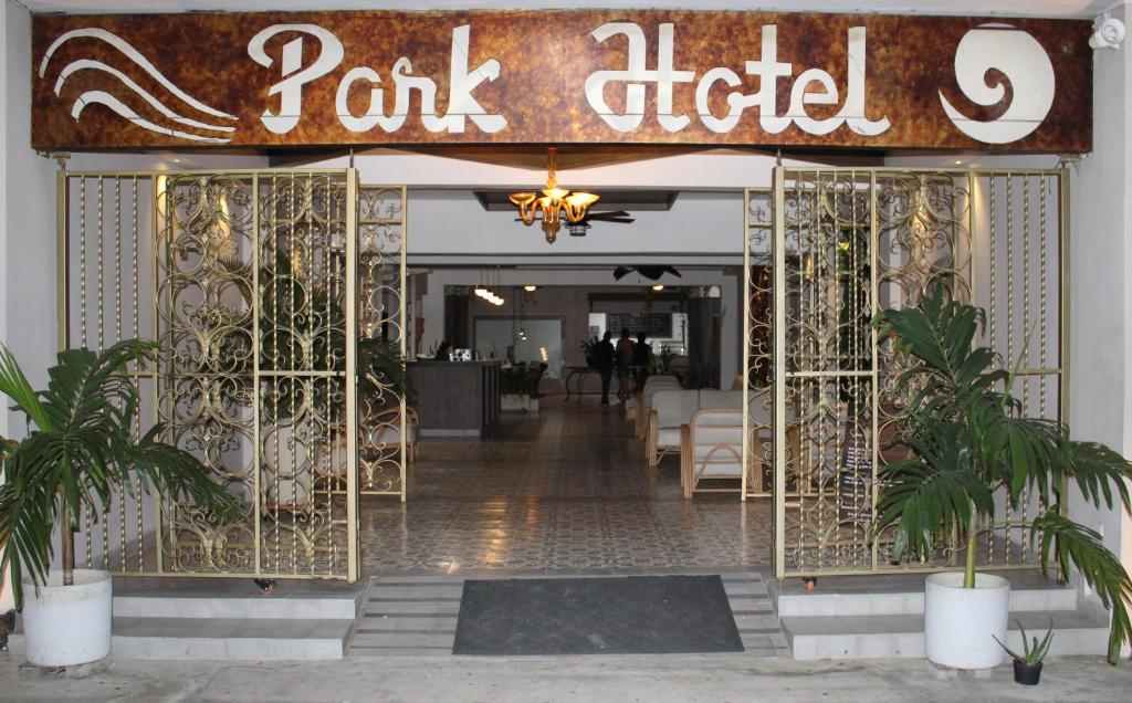 a restaurant entrance with a gate with a park relief sign at Park Hotel in Santa Marta