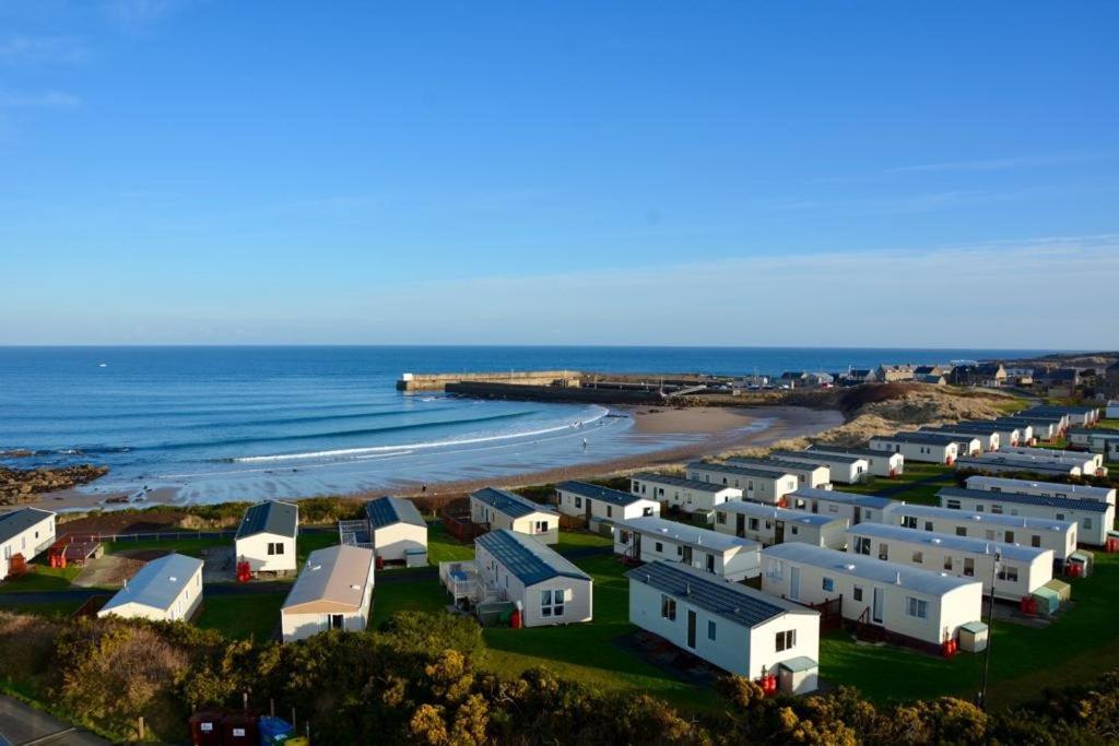 an aerial view of a row of houses on the beach at Gold Holiday Caravan: 3 bedroom Sleeps 6 (68) in Hopeman