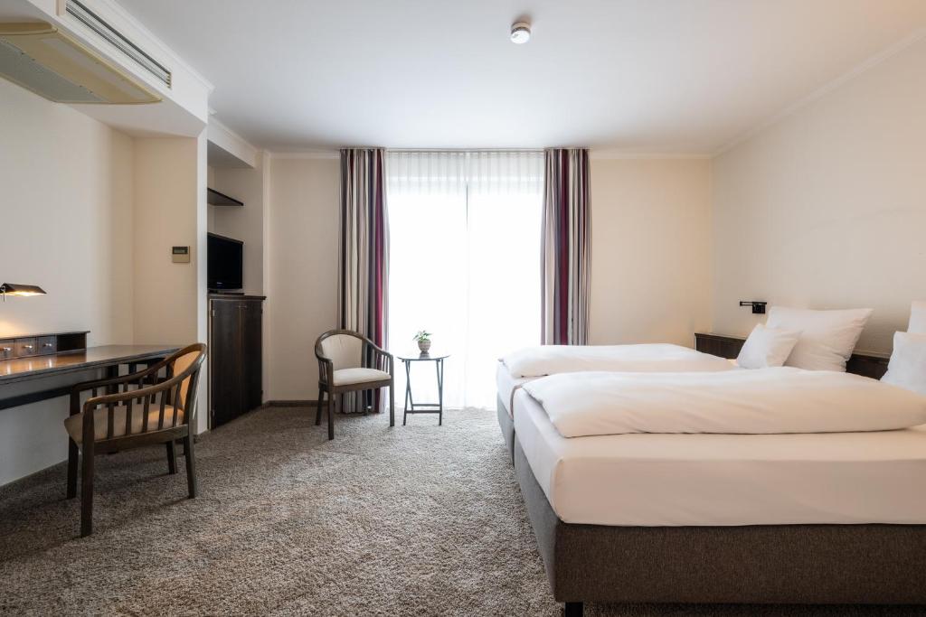 Postel nebo postele na pokoji v ubytování Hotel HerzogsPark