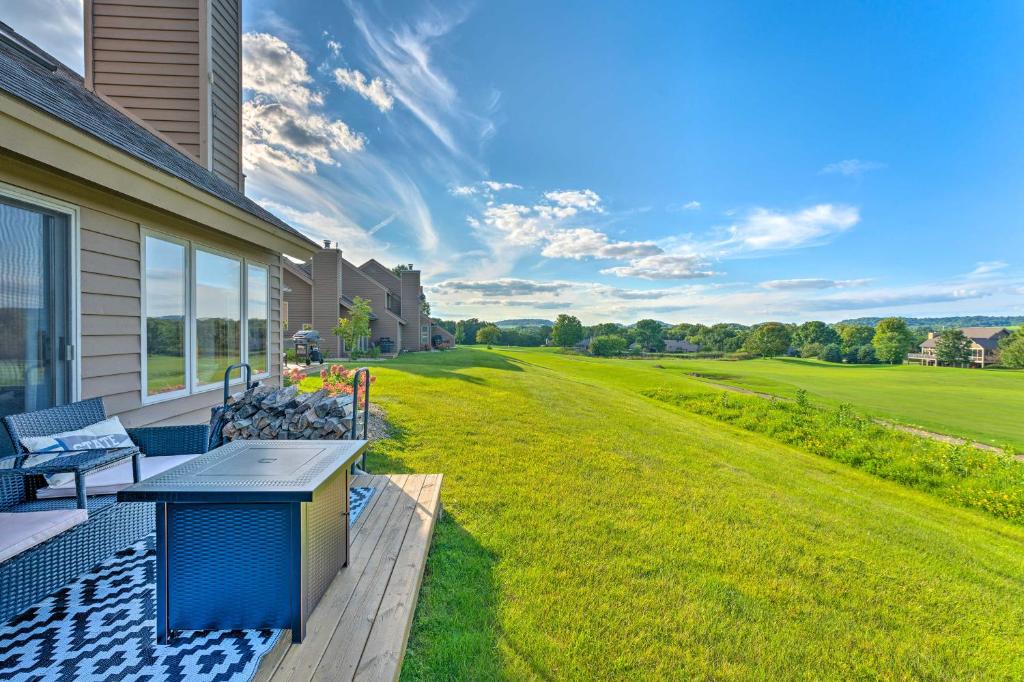 an outdoor patio with a table and chairs on a house at The Golf View, boutique Galena getaway! in Galena