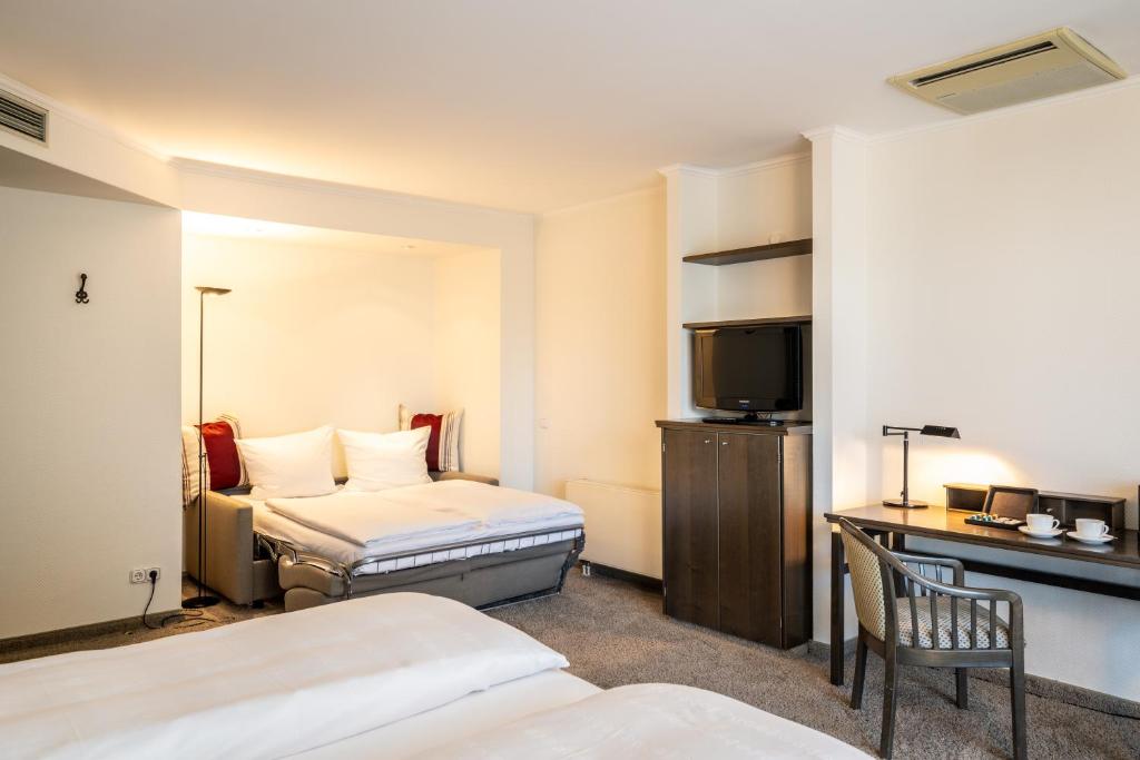 Postel nebo postele na pokoji v ubytování Hotel HerzogsPark