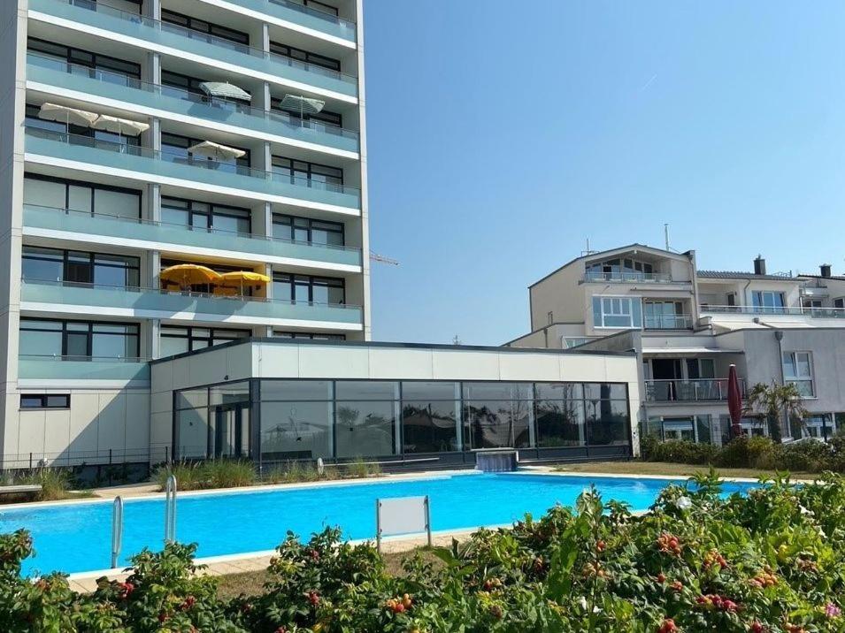 a large building with a swimming pool next to a building at Herrmann Jens in Pelzerhaken