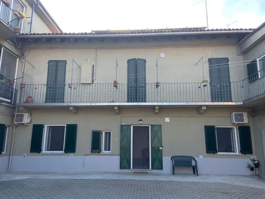 a building with a balcony with a bench in front of it at Al Canun di Casale Monferrato in Casale Monferrato