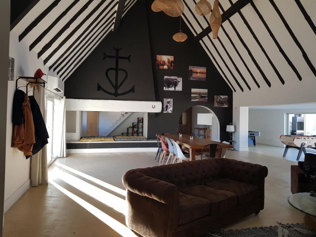 a living room with a couch and a table at La Cabane du Boumian in Saintes-Maries-de-la-Mer