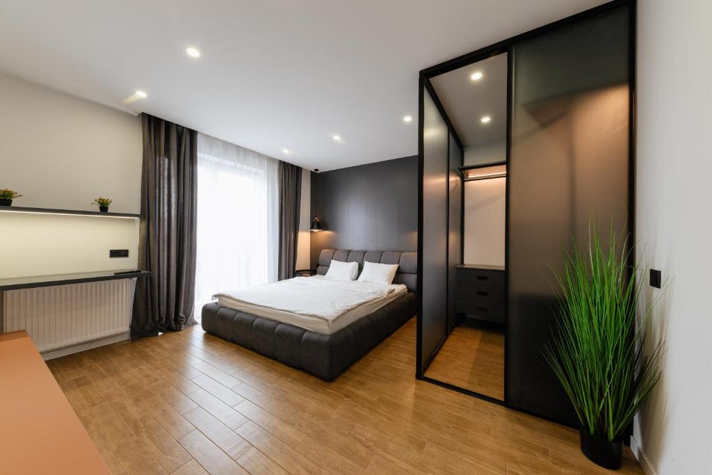 a bedroom with a bed and a large mirror at Luxury Apartments “Bozdosh” in Uzhhorod