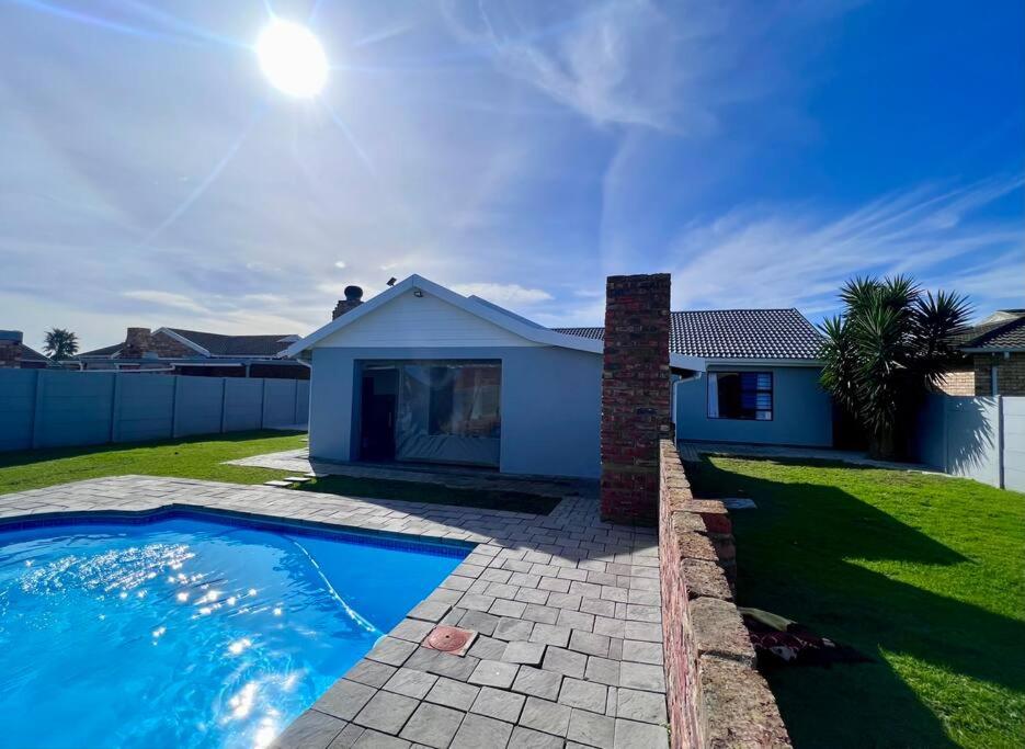 a house with a swimming pool in a yard at Family Holiday Home Rental in Port Elizabeth in Lorraine