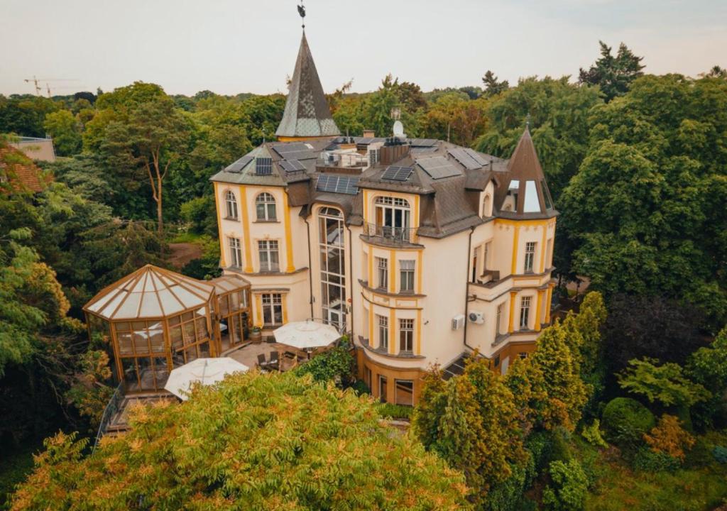 a large house with a tower on top of it at Grape Hotel in Wrocław