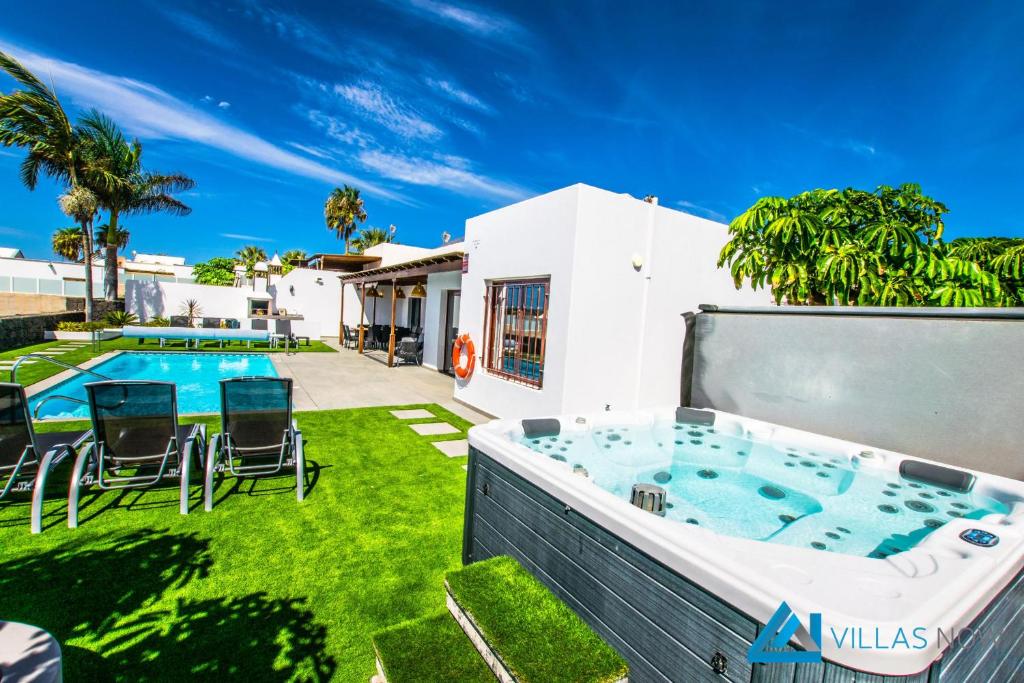 podwórko z wanną z hydromasażem i basenem w obiekcie 222 - Villa Noches De Luna by Villas Now Ltd w mieście Playa Blanca