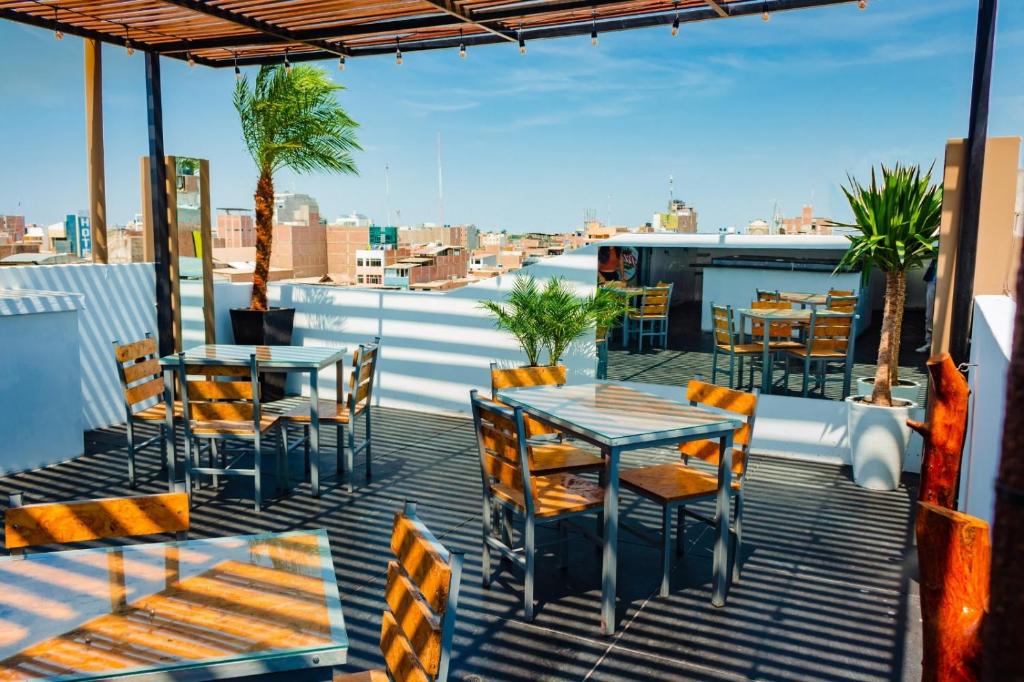 a patio with tables and chairs on a roof at Zentrico Hotel in Chiclayo