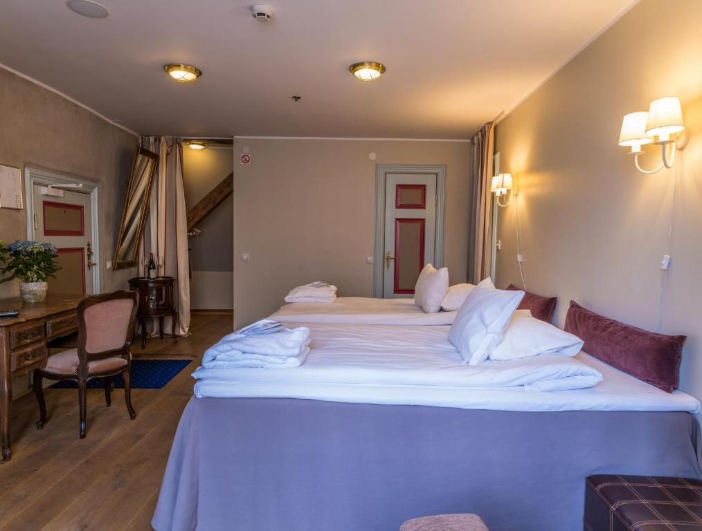 Postel nebo postele na pokoji v ubytování CRU Hotel