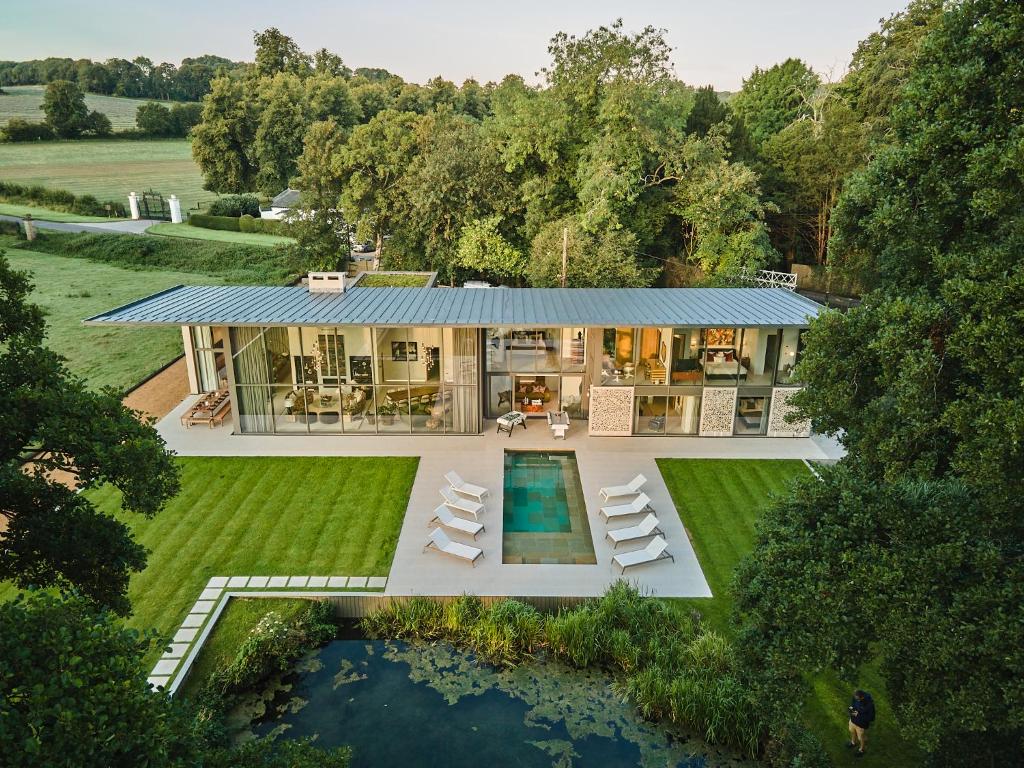 an aerial view of a house with a swimming pool at Avington Estate in Winchester