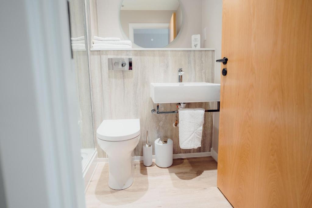a bathroom with a white toilet and a sink at The Dunes in Tenby