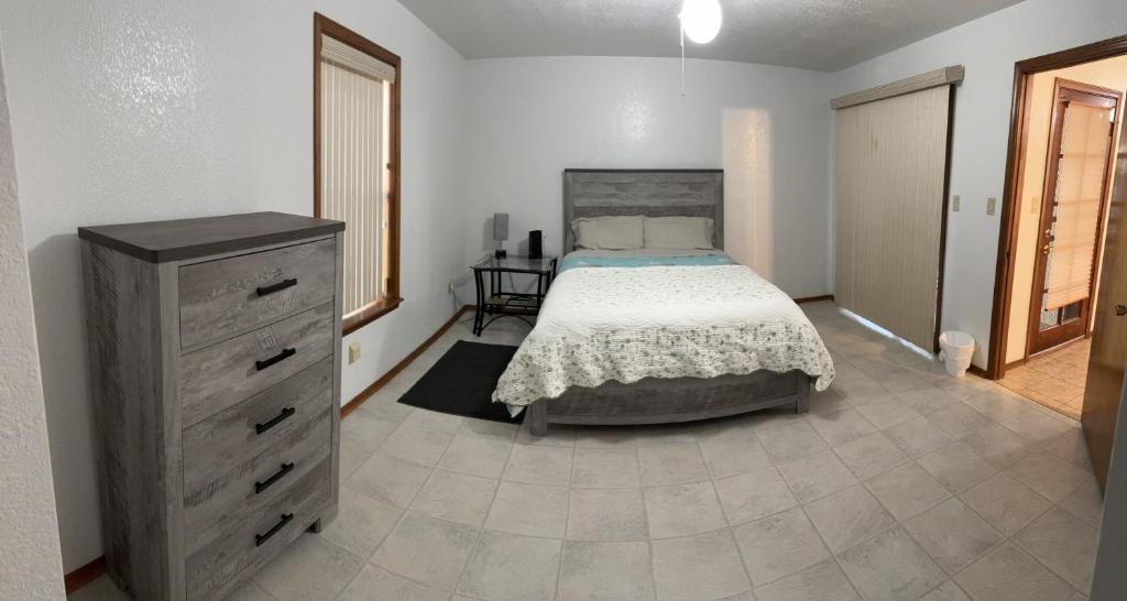 a bedroom with a bed and a dresser at Townhouse, two car garage, fireplace back yard in Las Cruces
