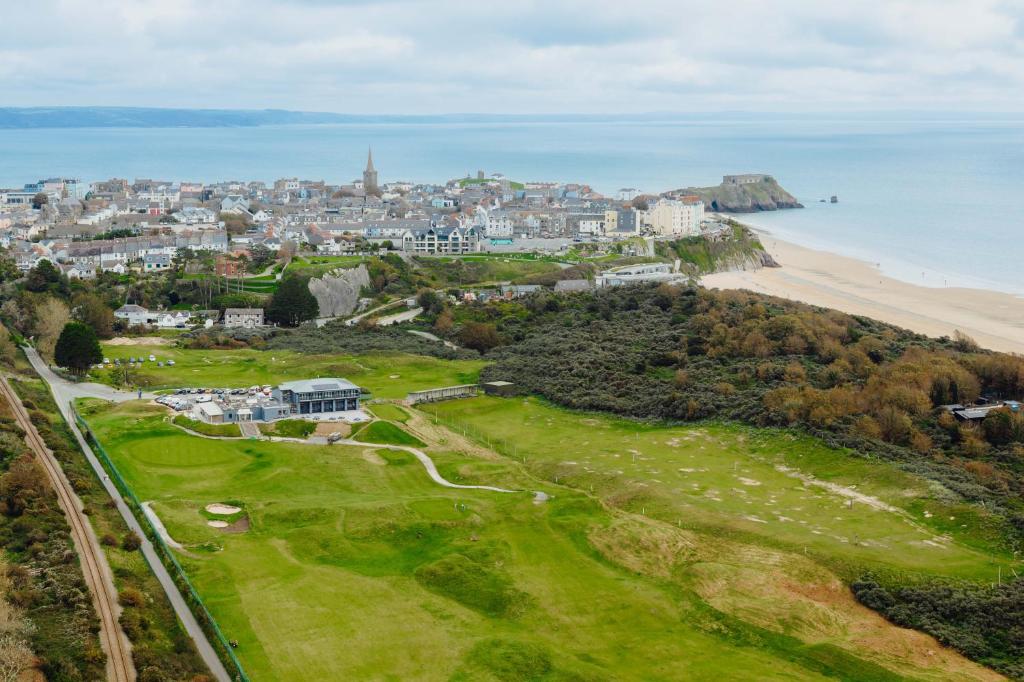 an aerial view of a golf course next to the beach at The Dunes in Tenby