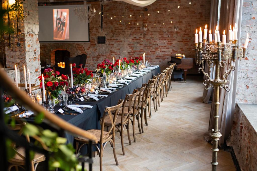 a long table in a room with chairs and candles at design LOFT 22 in Warsaw