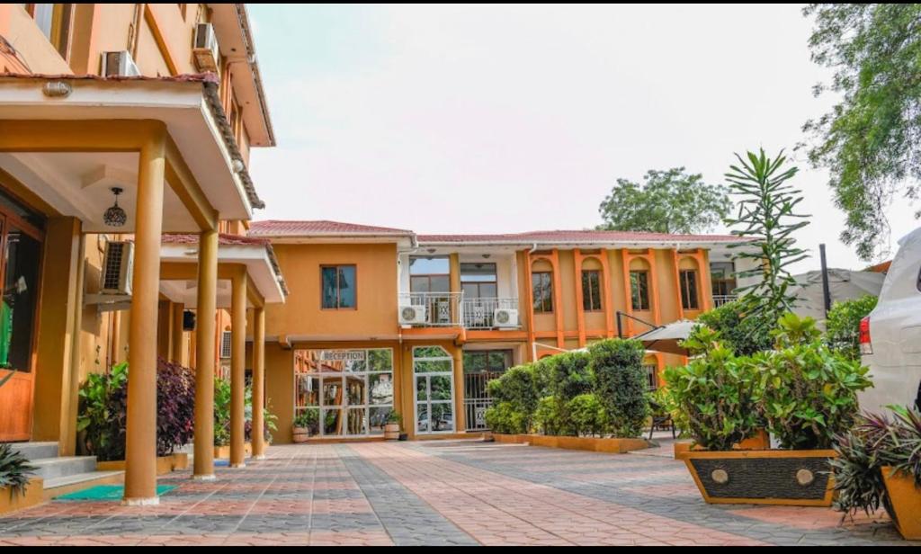 an empty courtyard of a building with plants at Aron International Hotel in Juba