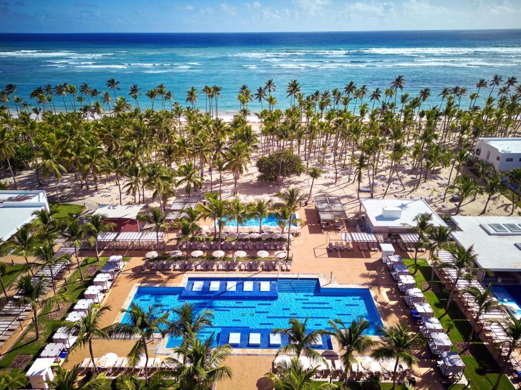 an aerial view of a resort with a pool and the ocean at Riu Palace Macao - Adults Only - All Inclusive Elite Club in Punta Cana