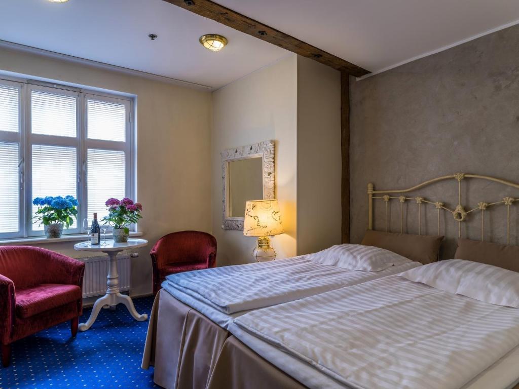 Postel nebo postele na pokoji v ubytování CRU Hotel