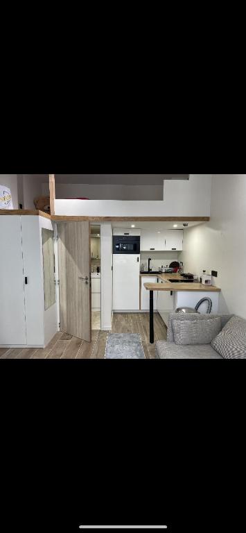 eine Küche und ein Wohnzimmer mit einem Tisch in der Unterkunft Appart au cœur de Bastille in Paris