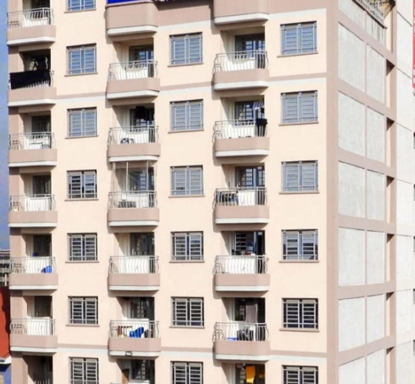 an apartment building with windows and balconies at Bliss Escapes in Ruiru