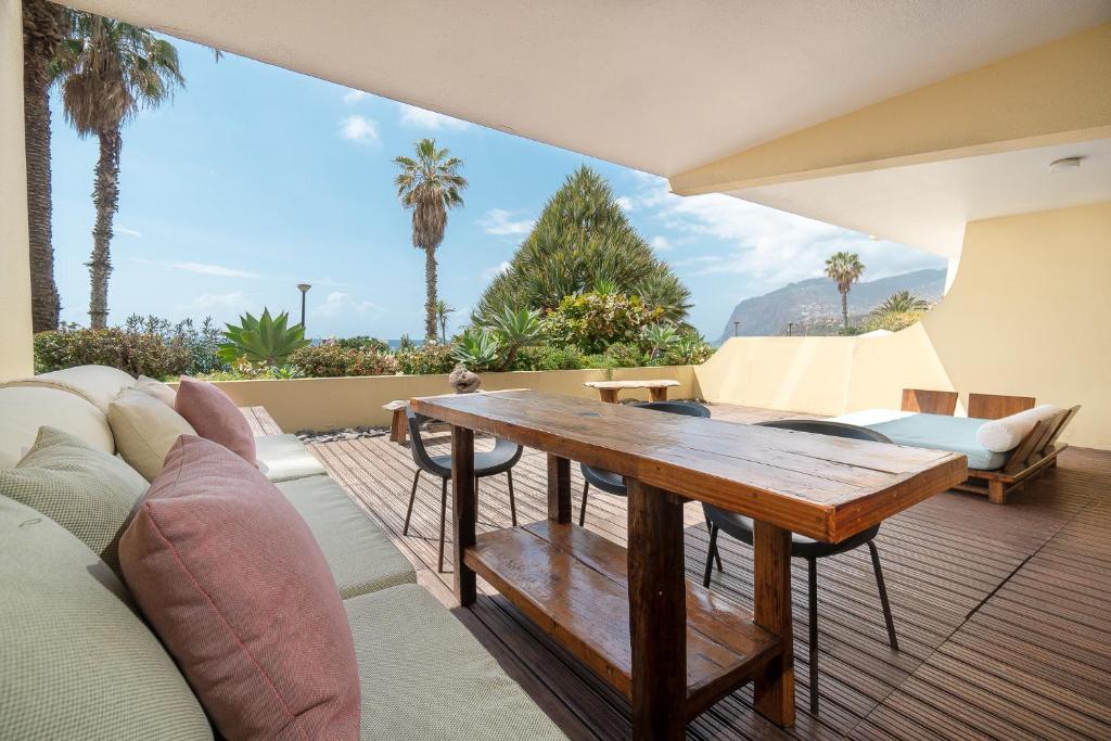 a living room with a couch and a wooden table at By the Atlantic Apartments 3-bedroom in Funchal