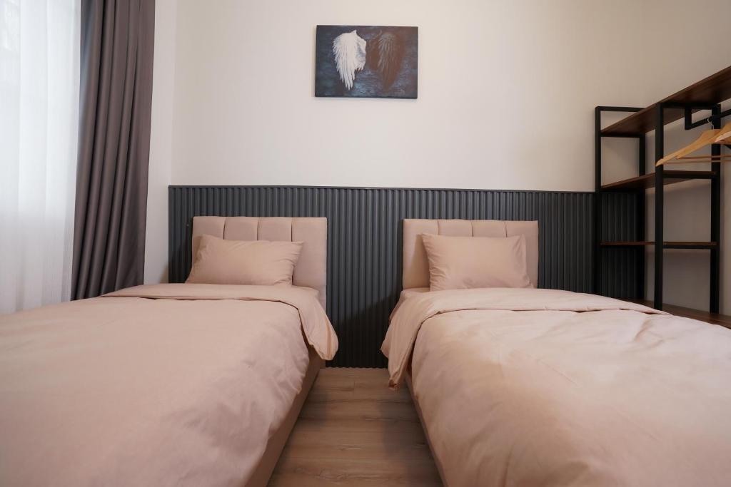 Postel nebo postele na pokoji v ubytování Merkuri apartments