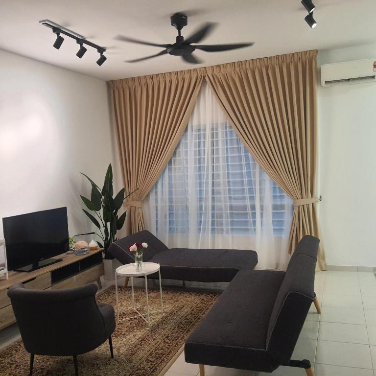 a living room with a couch and a ceiling fan at D Laman Haris Homestay in Bandar Puncak Alam